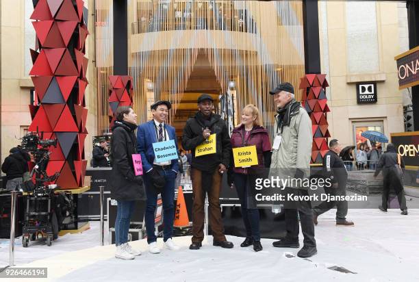 Stand-ins wearing name tags representing host and movie stars rehearse for the pre telecast show on the red carpet during preparations for the 90th...