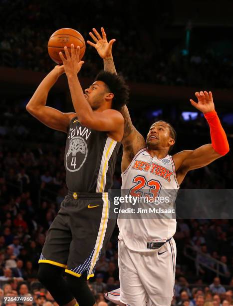 Quinn Cook of the Golden State Warriors in action against Trey Burke of the New York Knicks at Madison Square Garden on February 26, 2018 in New York...