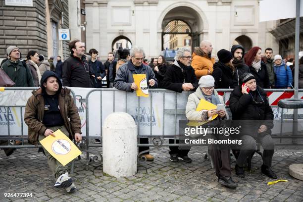 Attendees wait for the start of a general election campaign rally for Luigi Di Maio, leader of Italy's anti-establishment Five Star Movement, not...