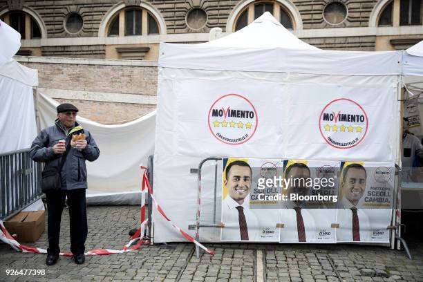 An attendee waits for the start of a general election campaign rally for Luigi Di Maio, leader of Italy's anti-establishment Five Star Movement, not...