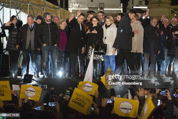 Luigi Di Maio, leader of Italy's anti-establishment Five Star Movement, center, waves to attendees during a general election campaign rally in Rome,...