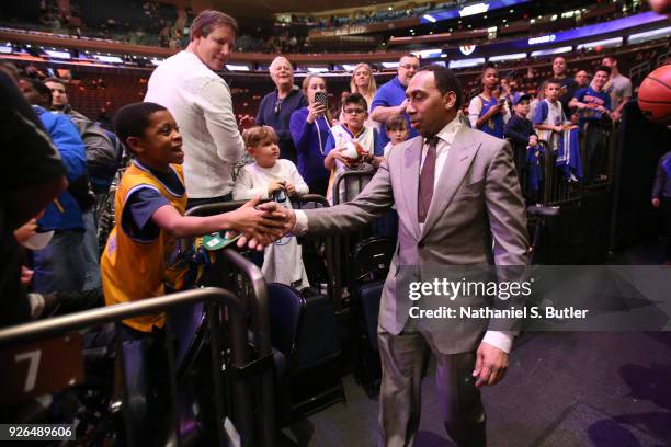 Stephen A. Smith of ESPN shakes a fans hand during the game between between the Golden State Warriors and against the New York Knicks on February 26,...