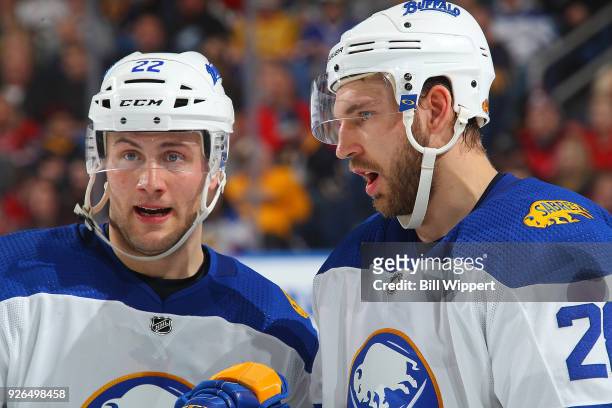 Johan Larsson and Zemgus Girgensons of the Buffalo Sabres chat during an NHL game against the Washington Capitals on February 19, 2018 at KeyBank...