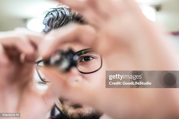 worker looking at a microchip - material science stock pictures, royalty-free photos & images