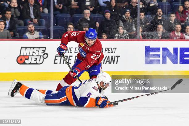 Andre Benoit of the Bridgeport Sound Tigers falls to the ice to defend against Niki Petti of the Laval Rocket during the AHL game at Place Bell on...