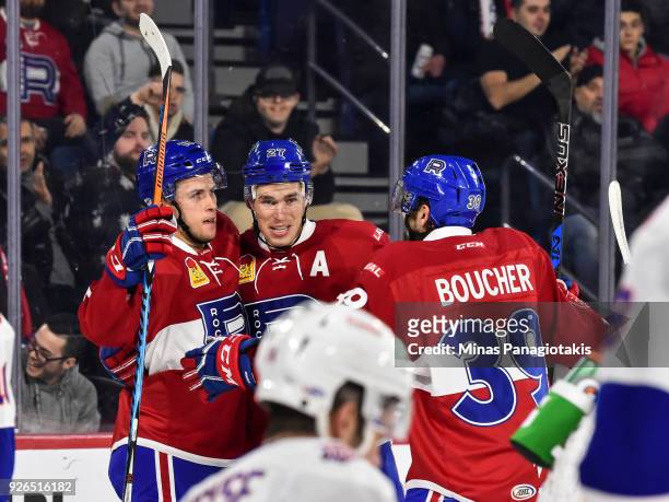 Kerby Rychel of the Laval Rocket celebrates a first period goal with teammates Adam Cracknell and Jordan Boucher against the Bridgeport Sound Tigers...