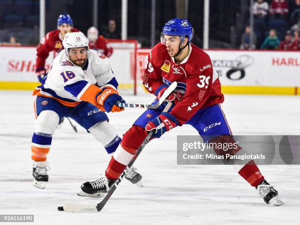 Jordan Boucher of the Laval Rocket skates the puck against Stephen Gionta of the Bridgeport Sound Tigers during the AHL game at Place Bell on March...