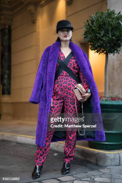 Guest is seen on the street attending Redemption during Paris Fashion Week Women's A/W 2018 Collection wearing a purple fur coat with pastel red...