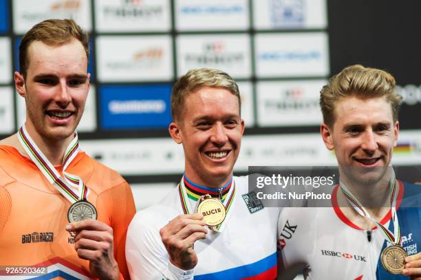 Sliver medalist Netherland's Jan Willem Van Schip, Gold medalist Australian Cameron Meyer and Bronze medalist Britton Mark Stweart pose on the podium...