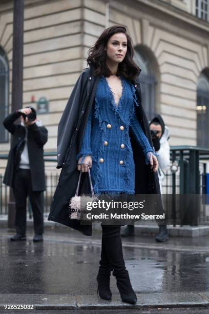 Guest is seen on the street attending Balmain during Paris Fashion Week Women's A/W 2018 Collection wearing a blue fringe dress with black thigh-high...
