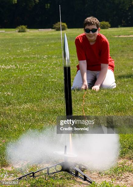 young kid preparing to launch a rocket - rocket engine stock pictures, royalty-free photos & images