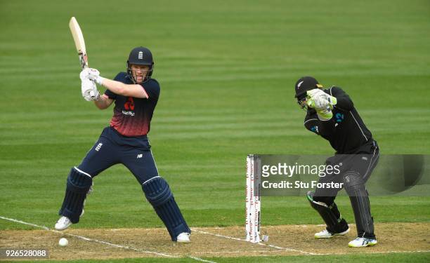 England batsman Eoin Morgan hits out watched by Tom Latham during the 3rd ODI between New Zealand and England at Westpac stadium on March 3, 2018 in...