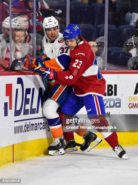 Niki Petti of the Laval Rocket pins Steve Bernier of the Bridgeport Sound Tigers against the boards during the AHL game at Place Bell on March 2,...