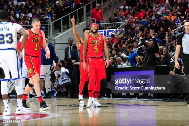 Mike Muscala of the Atlanta Hawks and Malcolm Delaney of the Atlanta Hawks react on the court against the Golden State Warriors on March 2, 2018 at...