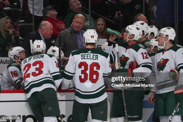 Head coach Bruce Boudreau of the Minnesota Wild talks to his team during a break in the action against the Colorado Avalanche at the Pepsi Center on...