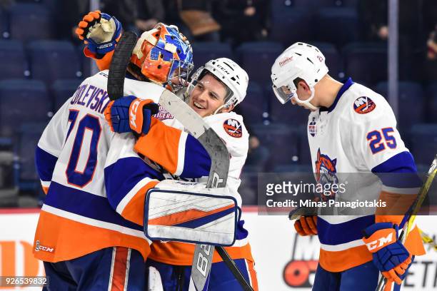 Travis St. Denis of the Bridgeport Sound Tigers celebrates a victory with goaltender Kristers Gudlevskis against the Laval Rocket during the AHL game...