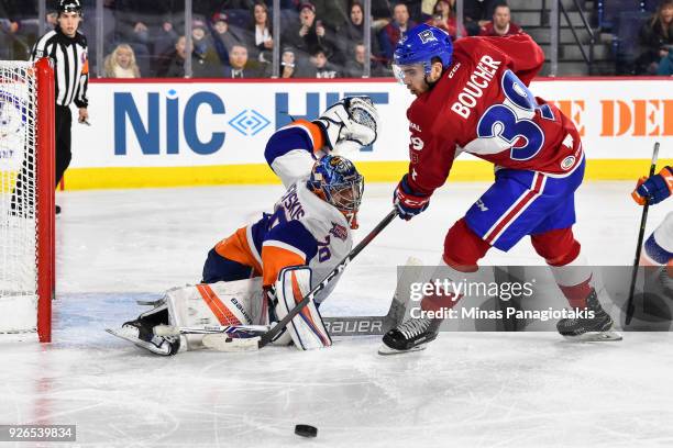 Goaltender Kristers Gudlevskis of the Bridgeport Sound Tigers makes a save on Jordan Boucher of the Laval Rocket during the AHL game at Place Bell on...