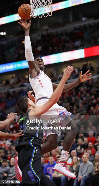Bobby Portis of the Chicago Bulls puts up a shot over Doug McDermott of the Dallas Mavericks at the United Center on March 2, 2018 in Chicago,...