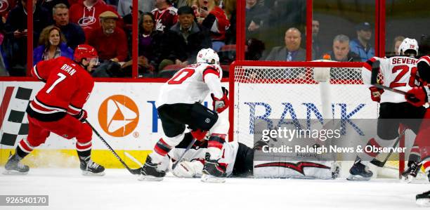 The Carolina Hurricanes' Derek Ryan scores against the New Jersey Devils' Michael Grabner , Keith Kinkaid and Damon Severson during the second period...