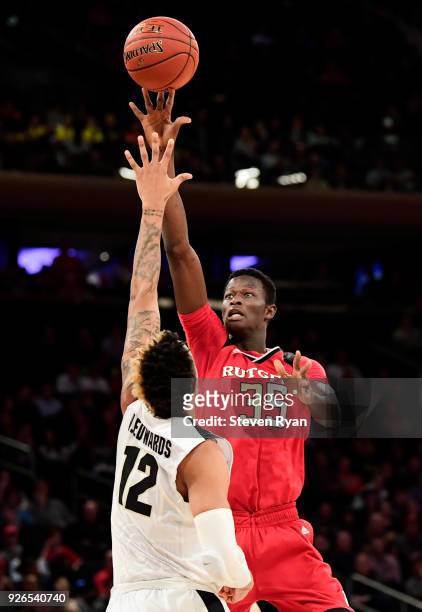 Issa Thiam of the Rutgers Scarlet Knights attempts a shot defended by Vincent Edwards of the Purdue Boilermakers during the quarterfinals of the Big...