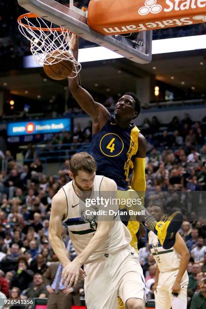 Victor Oladipo of the Indiana Pacers dunks the ball over Tyler Zeller of the Milwaukee Bucks in the third quarter at the Bradley Center on March 2,...