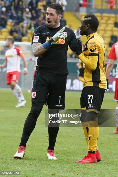 Goalkeeper Philipp Pentke of Regensburg and Moussa Kone of Dresden gesture during the Second Bundesliga match between SG Dynamo Dresden and SSV Jahn...