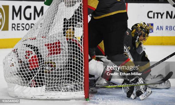 Mark Borowiecki of the Ottawa Senators slides into the net after Marc-Andre Fleury of the Vegas Golden Knights stopped his shot in the first period...