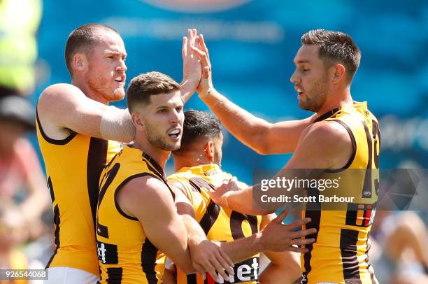 Jarryd Roughead of the Hawks is congratulated by his teammates after kicking a goal during the AFL JLT Community Series match between the Western...
