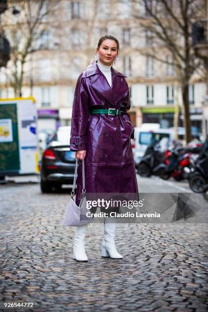 Angelica Ardasheva, wearing violet laminated trench, green belt and white heels boots, is seen in the streets of Paris after the Nina Ricci show...