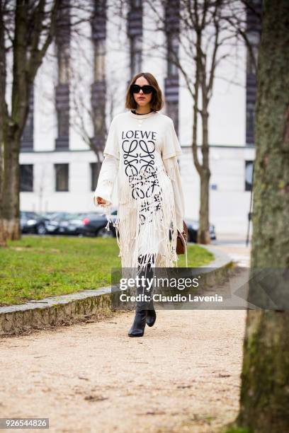 Candela Novembre, wearing Loewe dress and black heels boots, is seen in the streets of Paris before the Loewe show during Paris Fashion Week...