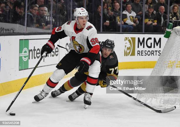 Magnus Paajarvi of the Ottawa Senators skates with the puck under pressure from Brad Hunt of the Vegas Golden Knights in the first period of their...