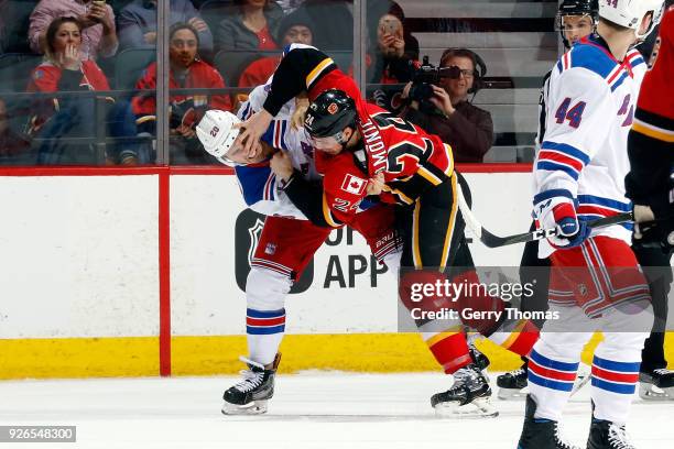 Travis Hamonic of the Calgary Flames fights Chris Kreider of the New York Rangers during an NHL game on March 2, 2018 at the Scotiabank Saddledome in...