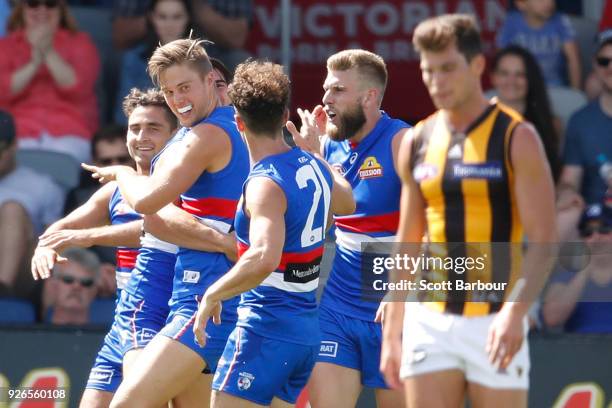 Josh Schache of the Bulldogs is congratulated by his teammates after kicking his first goal during the AFL JLT Community Series match between the...