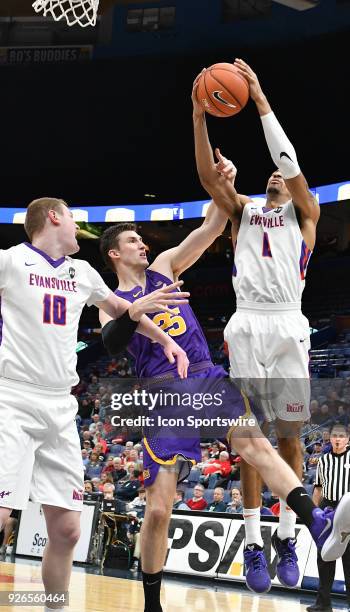 Forward Bennett Koch fouls Evansville guard Marty Hill during a Missouri Valley Conference Basketball Tournament game between the Evansville Purple...