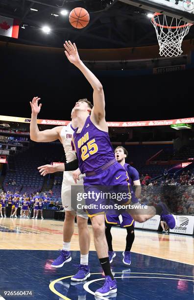 Forward Bennett Koch tries to block a shot by Evansville forward Evan Kuhlman during a Missouri Valley Conference Basketball Tournament game between...