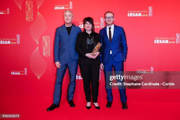 Producers Marie Ange Luciani, Hugues Charbonneau and film Director Robin Campillo pose with the Cesar award for Best Film for '120 Battements par...