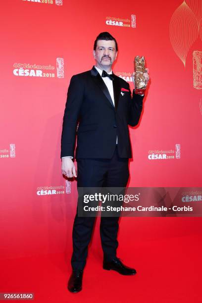 Arnaud Rebotini poses with the Cesar award for Best Original Score for '120 Battements par Minute' during the Cesar Film Awards at Salle Pleyel on...