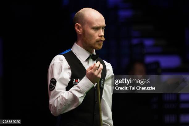 Gary Wilson of England chalks the cue during his quarter-final match against Yu Delu of China on day five of 2018 ManBetX Welsh Open at Motorpoint...