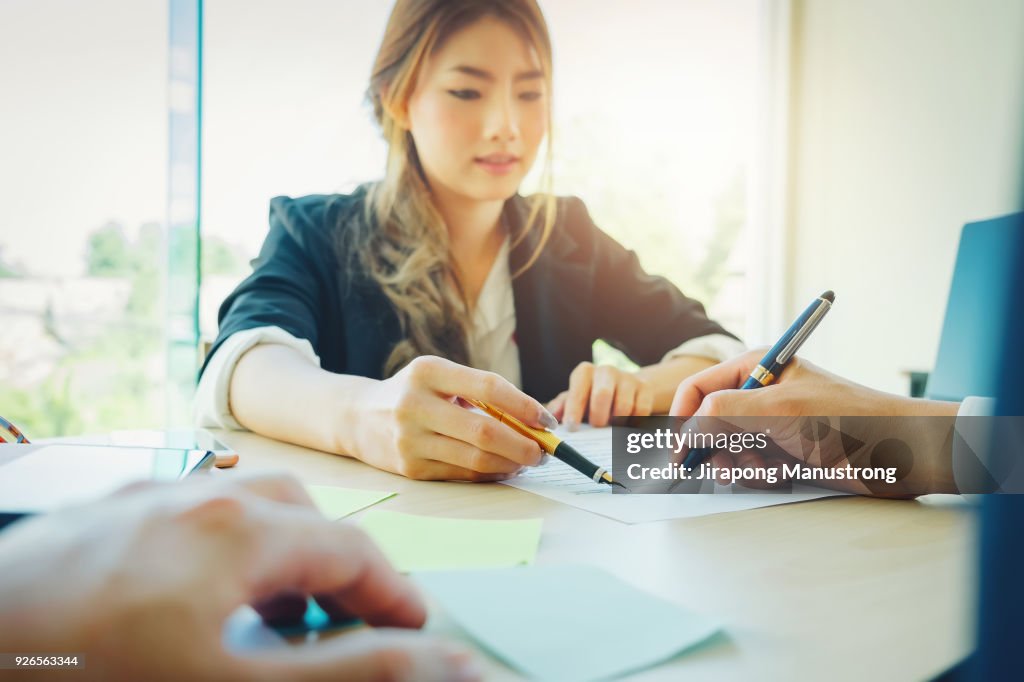 Agreement paper,estate agent gives pen and documents agreement with customer to sign contract.