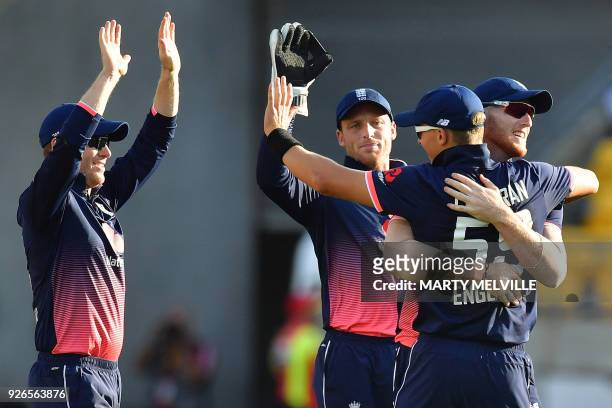 England's Ben Stokes celebrates New Zealand's Martin Guptill being caught with teammates Tom Curran , keeper Jos Buttler and captain Eoin Morgan...