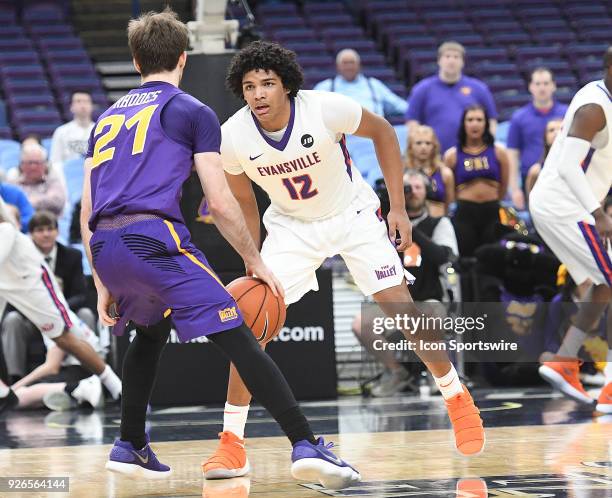 Guard Hunter Rhodes works the ball against Evansville guard Dru Smith during a Missouri Valley Conference Basketball Tournament game between the...