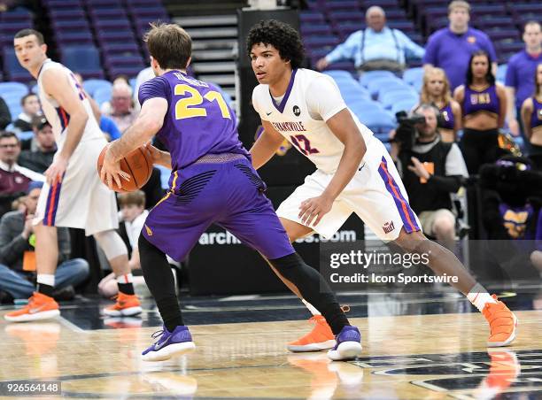 Evansville guard Dru Smith challenges UNI guard Hunter Rhodes during a Missouri Valley Conference Basketball Tournament game between the Evansville...