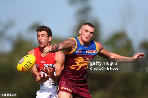 Robbie Fox of the Swans has a mark spoiled by Mitch Robinson of the Lions during the AFL JLT Community Series match between the Brisbane Lions and...