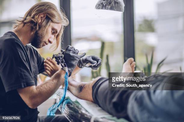 leg tattooing - surgical needle stock pictures, royalty-free photos & images