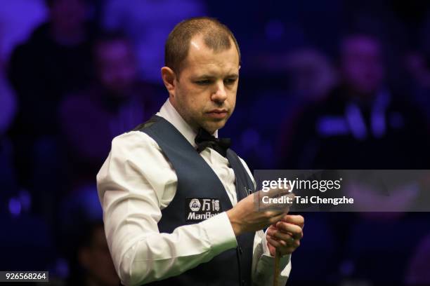 Barry S. Hawkins of England chalks the cue during his quarter-final match against Yan Bingtao of China on day five of 2018 ManBetX Welsh Open at...