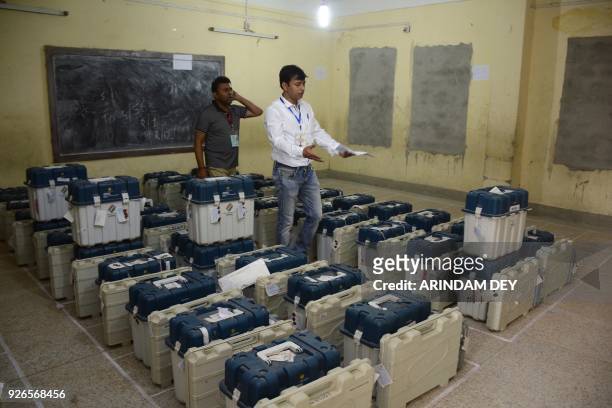 Indian election officials prepare Electronic Voting Machines before they are brought to the counting hall to tally votes in the Tripura legislative...