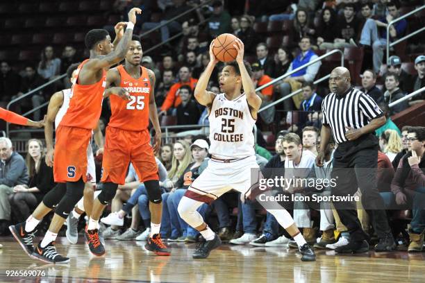 Boston College Eagles guard Jordan Chatman tries to get the pass past the two defenders. During the Boston College Eagles game against the Syracuse...