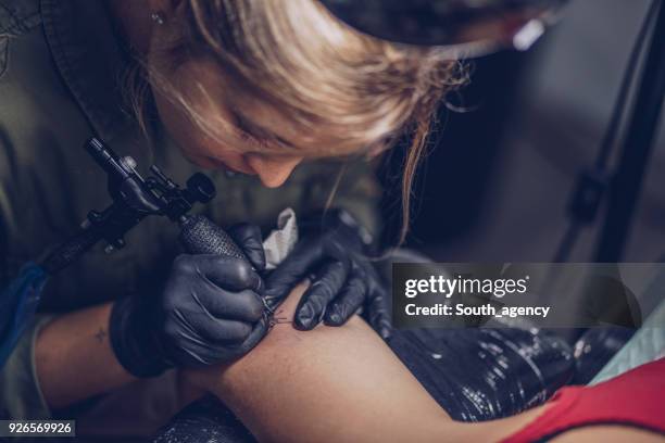 young woman tattoo artist - surgical suture stock pictures, royalty-free photos & images