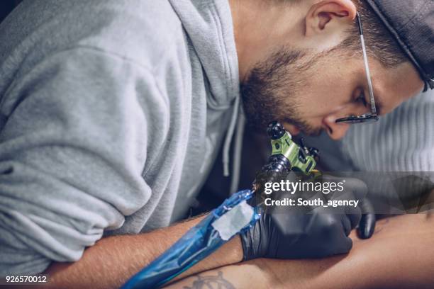 tattoo in making - surgical needle stock pictures, royalty-free photos & images