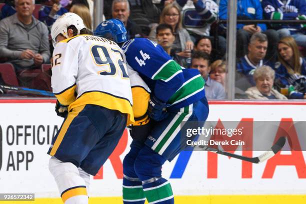 Ryan Johansen of the Nashville Predators spears Erik Gudbranson of the Vancouver Canucks during their NHL game at Rogers Arena on March 2, 2018 in...